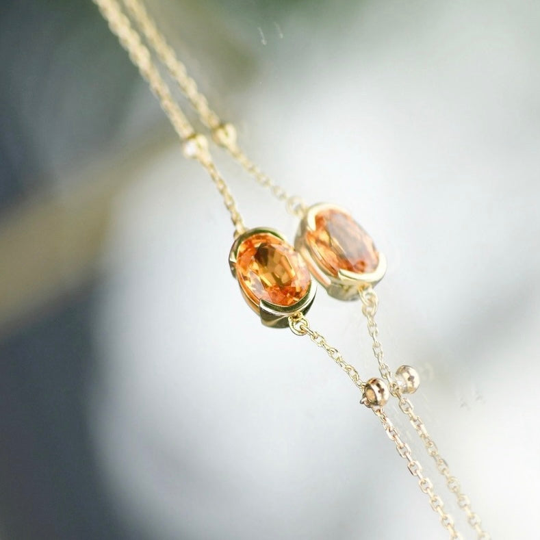 Oval-Shaped Natural Spessartine with Natural Diamond Earrings in 18K Gold